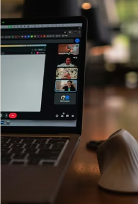 Laptop showing an online meeting with blurred background